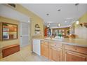 View of the kitchen flowing into living space, featuring wood cabinets and tile flooring at 175 Kings Hwy # 226, Punta Gorda, FL 33983
