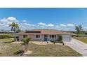 Charming single-story home with a well-maintained yard and a neutral color palette at 18106 Petoskey Cir, Port Charlotte, FL 33948