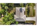 A quaint home with mature trees and an expansive roof is shown in this picturesque aerial view at 2192 Hyatt Dr, Port Charlotte, FL 33948