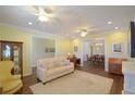 Inviting living room with neutral sofa, and an open floorplan to the dining room at 2227 Bonn Ct, Punta Gorda, FL 33983