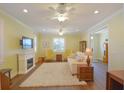 Cozy living room with fireplace, plush seating, ceiling fans, and bright natural light at 2227 Bonn Ct, Punta Gorda, FL 33983
