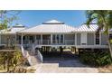 Beautiful raised beach home with a metal roof, expansive deck, and covered parking at 24139 Jolly Roger Blvd, Punta Gorda, FL 33955