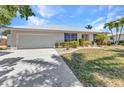 Charming single-story home with a well-manicured lawn, beautiful landscaping, and a convenient two-car garage at 2718 Saint Thomas Dr, Punta Gorda, FL 33950