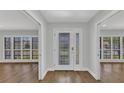 Bright and spacious foyer featuring a decorative glass front door, gleaming hardwood floors, and access to living spaces at 2718 Saint Thomas Dr, Punta Gorda, FL 33950
