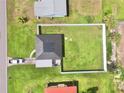 Aerial view of home showing large, fenced in yard, modern roof, and neighborhood layout at 3324 Port Charlotte Blvd, Port Charlotte, FL 33952