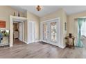 Bright foyer features light wood flooring, a coat closet, and decorative double doors at 4473 Sweetbay St, Port Charlotte, FL 33948