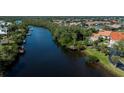Beautiful water view with a private dock, mature trees, and lush landscaping that gives a peaceful vibe at 5061 San Rocco Ct, Punta Gorda, FL 33950