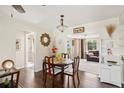 Cozy dining area features hardwood floors and seamless access to the living room, bathed in natural light at 558 Azalea Drive, Port Charlotte, FL 33952