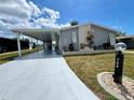 Charming single-story home features a covered carport and beautiful landscaping at 749 Watersedge St, Englewood, FL 34223