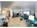 Open living room featuring tile floors, recessed lighting, and stylish furnishings at 931 Juno Dr, Punta Gorda, FL 33950