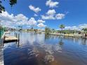 Scenic waterfront view with docks and beautiful waterfront homes under a sunny sky at 931 Juno Dr, Punta Gorda, FL 33950