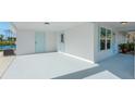 Spacious covered porch featuring a concrete floor, two doors, and adjacent windows at 1020 Drury Ln, Englewood, FL 34224