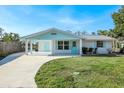 Charming single-story home with a well-manicured lawn, a spacious driveway and covered porch at 1020 Drury Ln, Englewood, FL 34224