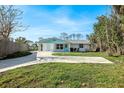 Charming single-story home with a well-manicured lawn, a spacious driveway and covered porch at 1020 Drury Ln, Englewood, FL 34224