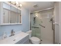 Clean bathroom featuring glass-enclosed shower with a grab bar, neutral color palette, and a sleek vanity at 1051 Forrest Nelson Blvd # 104, Port Charlotte, FL 33952