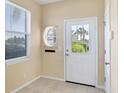 Bright entryway with tile flooring, window, and glass paneled door at 1085 Jonah Dr, North Port, FL 34289