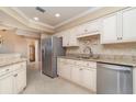 Well-lit kitchen showcasing granite countertops, modern stainless steel appliances, and sleek cabinetry at 1326 Wesley Dr # 123, Punta Gorda, FL 33950