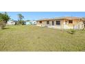 Large backyard featuring chain link fence, an outbuilding and plenty of room for outdoor activities at 167 N Cambridge Nw Dr, Port Charlotte, FL 33952