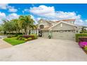 Beautiful home with well-manicured landscaping, a three-car garage, and a tile roof at 1814 Pinyon Pine Dr, Sarasota, FL 34240