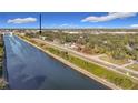 Scenic aerial view highlighting the property's waterfront location and proximity to green spaces and the river at 1851 Scenic Dr, Venice, FL 34293
