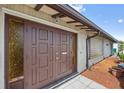 Close-up of the inviting front door showcasing its unique design and character at 21169 Edgewater Dr, Port Charlotte, FL 33952