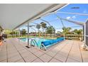 Relaxing screened-in pool area with tiled deck, perfect for enjoying the Florida sunshine at 21169 Edgewater Dr, Port Charlotte, FL 33952