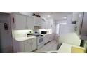 Well-lit kitchen featuring white appliances, ample cabinet space, and tile flooring at 21342 Walling Ct, Port Charlotte, FL 33954