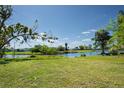 Expansive backyard with lush green grass and a tranquil canal view at 2230 Harbor Blvd, Port Charlotte, FL 33952