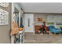 Inviting home entryway features wood-look flooring, decorative furnishings, and an abundance of natural light at 2236 Arnet St, Port Charlotte, FL 33948