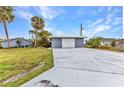 Well-maintained home exterior featuring a long driveway and attached garage at 2236 Arnet St, Port Charlotte, FL 33948