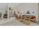 Bright living room featuring tile floors, high ceilings, and a decorative pelican wall hanging at 23104 Turnbull Ave, Port Charlotte, FL 33954