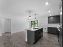 Modern kitchen with an island, stainless steel appliances, and stylish gray cabinets at 2372 Bonanza Ln, North Port, FL 34286