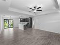 Bright living room boasts an open floor plan, tile floors, and modern gray kitchen at 2372 Bonanza Ln, North Port, FL 34286