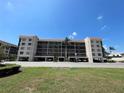 Exterior of condo building featuring covered parking, neutral paint, and a well-maintained landscape at 25188 Marion Ave # F307, Punta Gorda, FL 33950
