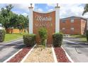 Maria Manor's entrance sign with brick accents, surrounded by well-maintained landscaping at 4158 Tamiami Trl # G1, Port Charlotte, FL 33952