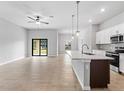 Bright, open kitchen with stainless appliances, stone countertops and light-filled dining and living spaces at 4425 Lagoon Ter, North Port, FL 34286
