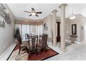 Open dining area featuring a glass table, modern lighting, and views of the foyer at 48 Colony Point Dr, Punta Gorda, FL 33950