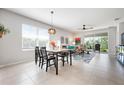 Open-concept living space with dining area, comfortable seating, and ample natural light from large windows at 7209 W Lenox Cir, Punta Gorda, FL 33950