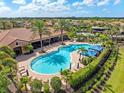 Resort-style community pool with ample seating, cabanas, and lush landscaping, providing a luxurious and relaxing experience at 8725 Amaretto Ave, Sarasota, FL 34238