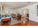 Bright living room with hardwood floors, large windows, and stylish decor, offering a comfortable living space at 114 Mcgregor St, Punta Gorda, FL 33950