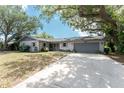 Lovely single-story home featuring a long driveway and a charming stone-accented entryway at 1173 Belmar Ave, Port Charlotte, FL 33948