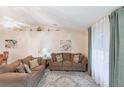 Bright living room featuring neutral walls, a ceiling fan, comfortable sofas, and decor at 1381 Fargo St, Port Charlotte, FL 33952