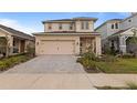 Two-story home featuring a neutral color scheme, attached garage and a driveway made of paving stones at 15975 Mulrion Blvd, Punta Gorda, FL 33982