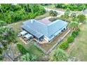 Aerial view of a single-story home with a fenced backyard and covered patio at 17506 Cape Horn Blvd, Punta Gorda, FL 33955