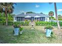 Backyard view showcasing a screened-in patio area with an outdoor seating and lush landscaping at 17506 Cape Horn Blvd, Punta Gorda, FL 33955