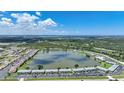 Expansive aerial view of the condo community surrounding a lake with fountain and lush greenery at 25225 Rampart Blvd # 1607, Punta Gorda, FL 33983