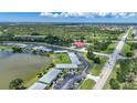 Aerial view showcasing the condo community, lake, landscaping, and surrounding area at 25225 Rampart Blvd # 1607, Punta Gorda, FL 33983