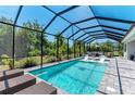 Sparkling pool with screened enclosure, lounge chairs, and patio area for relaxation at 2636 Mauritania Rd, Punta Gorda, FL 33983