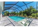 Inviting screened pool with lounge chairs, offering a perfect outdoor retreat at 2636 Mauritania Rd, Punta Gorda, FL 33983