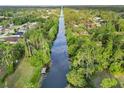 Aerial view of a canal lined with lush trees at 2776 Tusket Ave, North Port, FL 34286